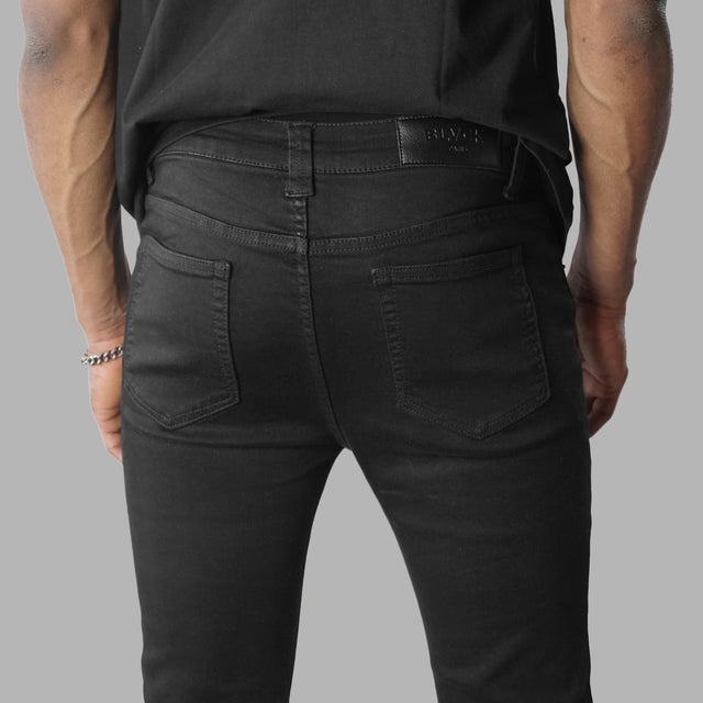 Jean noir déchiré avec monogrammes Blvck